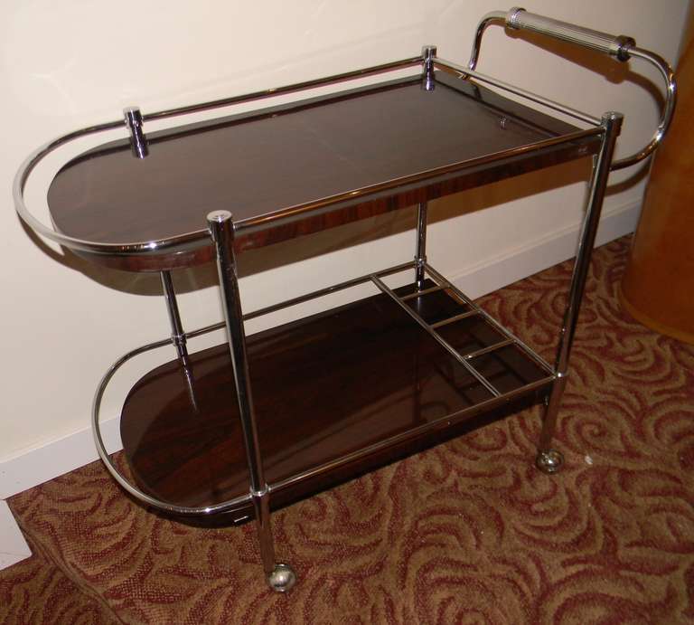 A perfectly restored bar cart. Nice Art Deco design with newly re-chromed frame. Great storage for bottles, shakers, champagne buckets and just about anything you need for that sophisticated after or before dinner libation.  A must for cocktail