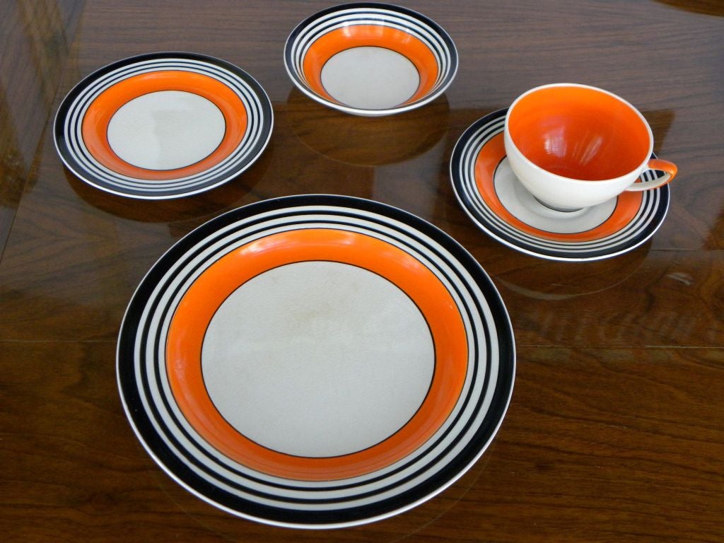 This is an exciting Susie Cooper,  thirty one piece set of the striking modernist china by one of  Britain’s  most re-known ceramicists and dinnerware designers.  Created in1933 the graduated black bands on cream background comes alive with bright