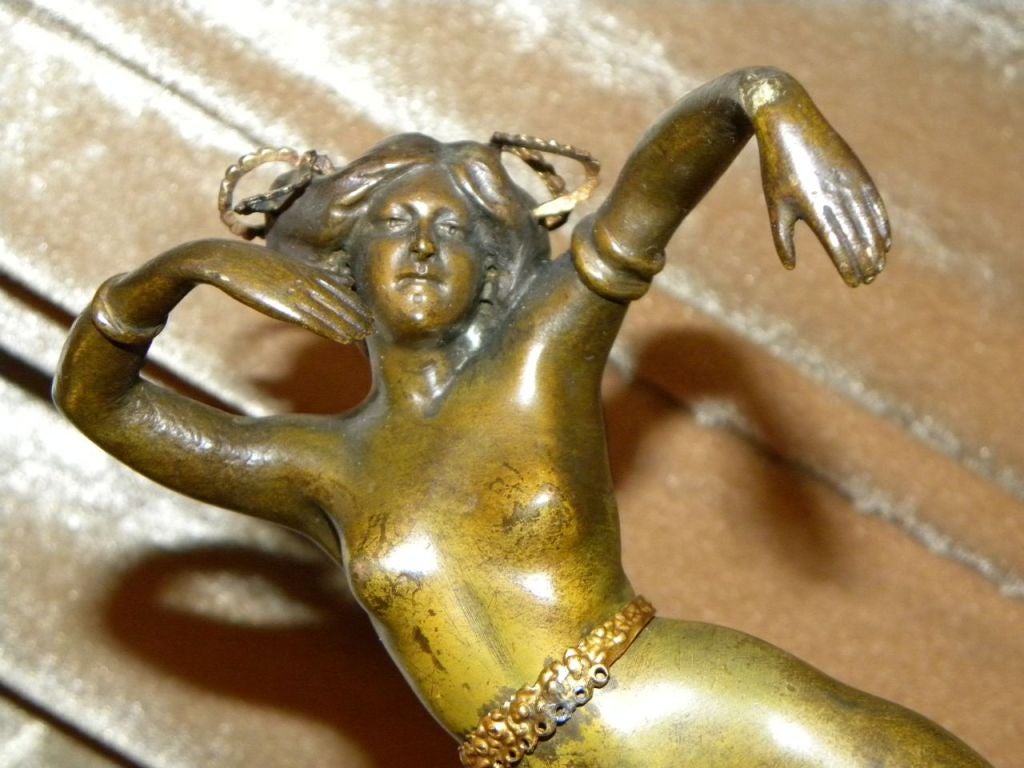 This wonderful and sexy boudoir piece by Austrian sculptor. S. Bauer. Executed in brown patinated bronze with gold details represents this rather inquisitive carefree dancer. Her body is well formed and the lyrical style of body and arm posture,