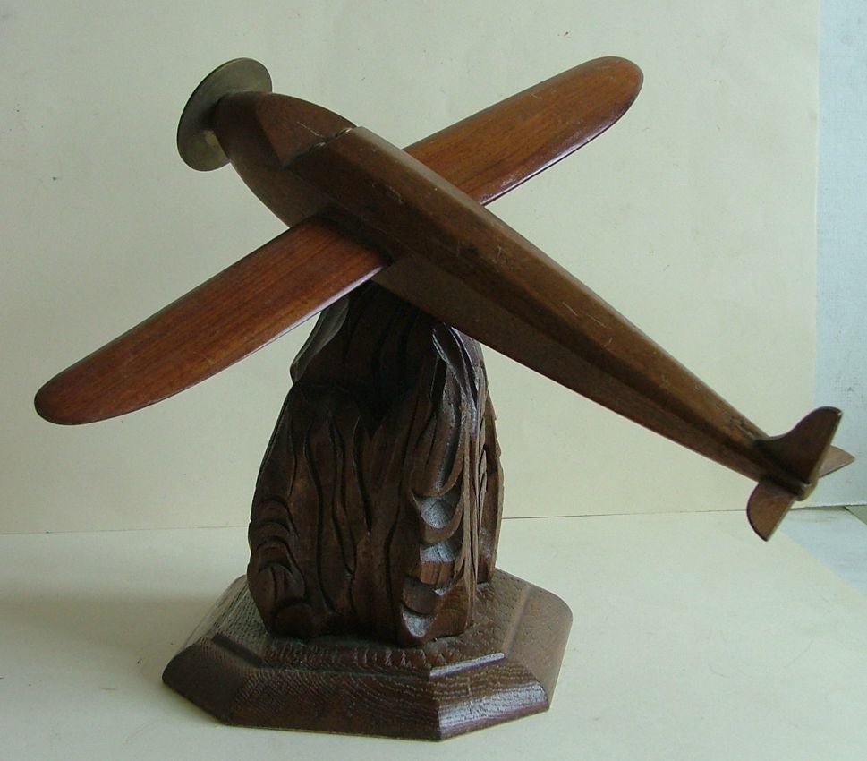 A very interesting and nicely carved Art Deco wooden model of a pre war mono winged airplane that looks to have been inspired by the Bleriot 111 of 1930. Lovely solid rosewood fuselage and wings with bronze propellor and cockpit detail, the