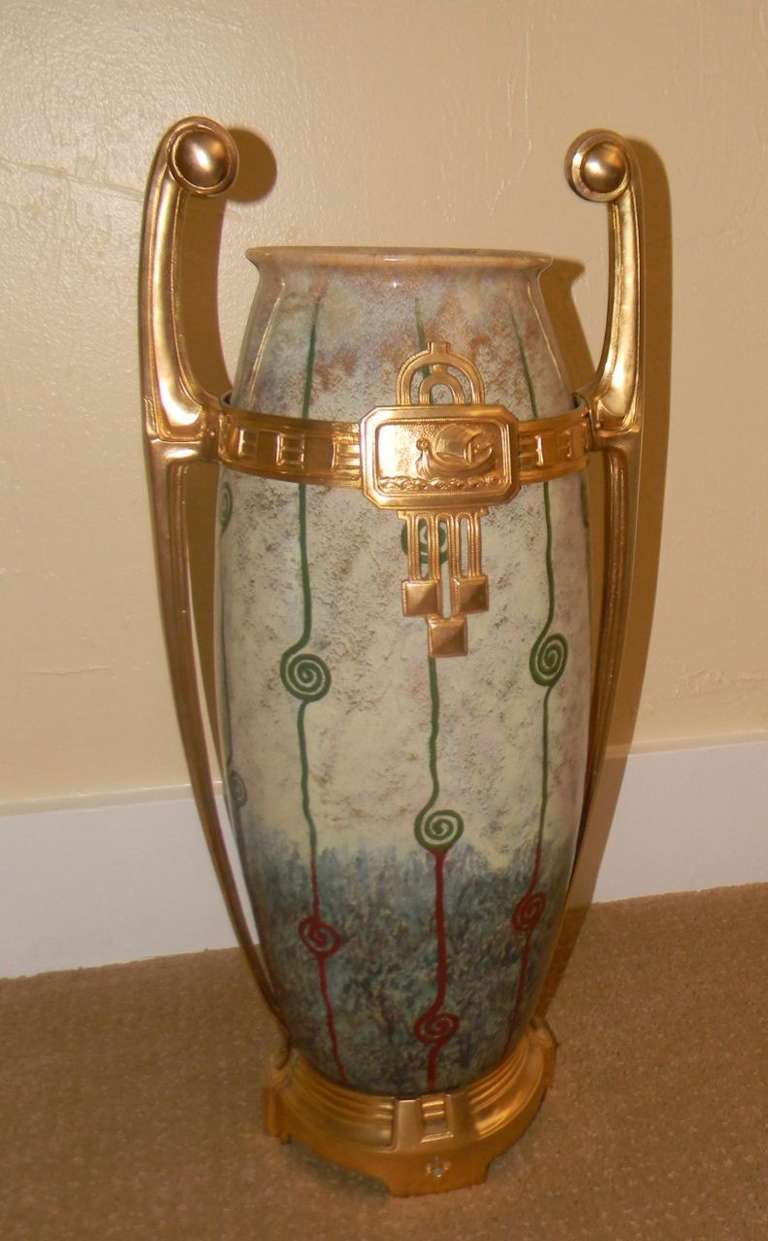 Art Nouveau or Jugendstil was an international movement spreading from european countries like Great Britain, France, Belgium, Germany and Austria all over the world. This spectacular ceramic vase with important metalwork,  I believe is either