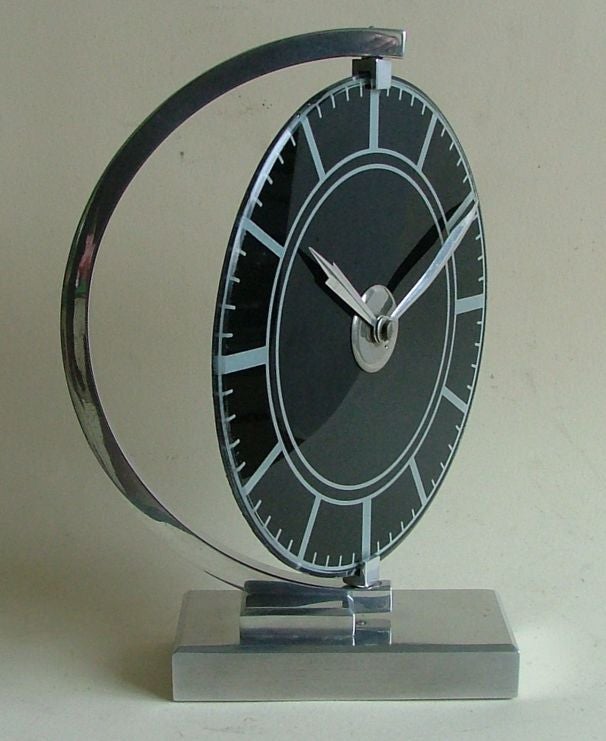 Extremely rare modernist European clock. I beautiful object with visual balance.  All metal parts are polished aluminum and are all in perfect condition with no damages or repairs, dial is reverse painted glass in silver and black and it's really a