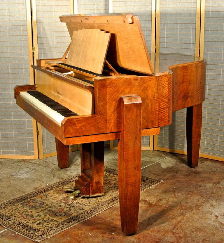 Graceful two-toned mahogany and maple cabinet raised on streamline supports in the most sophisticated 1930s French high style. Also accented by an unusual wood and brass lyre. Gaveau pianos made some of the finest Art Deco art-case pianos known.