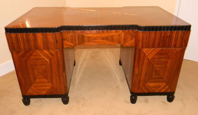 Wow, I'd sure like to be sitting behind this stunning executive desk.  Just in and newly refinished, original 
Zebra wood with tremendous wood details and marquetry. It would make just about anyone happy.  Take a close look at the top, great