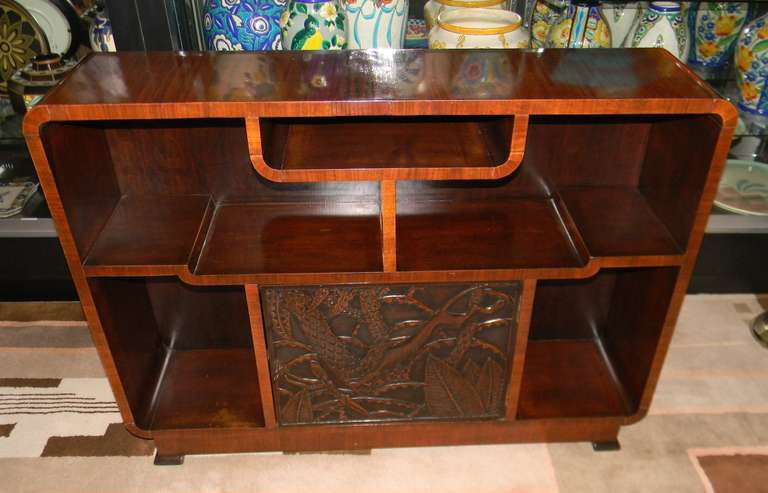 A stunning hand carved Bar storage unit. Great looking piece of original furniture,  deeply carved with an unusual African primitive island motif. Look closely at the lion chasing the man in a forest of palm tree's and leaves.  There are also great
