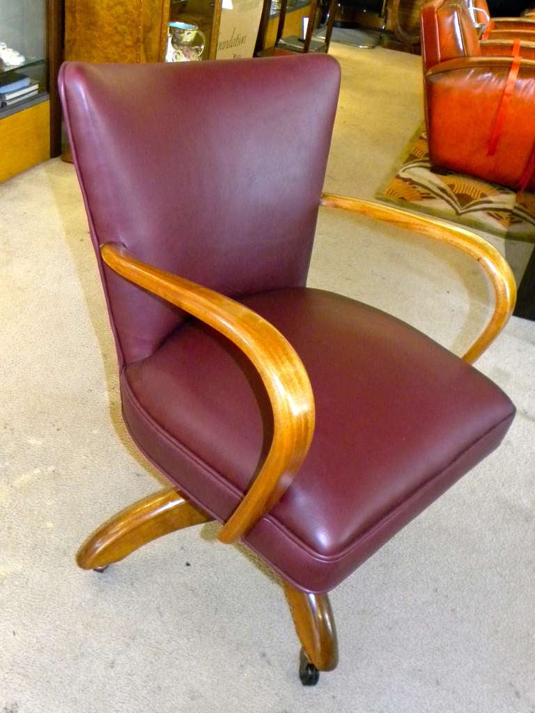 We just finished restoring this beauty and it really is nice! Great shape and quite unique. Original wood with a refreshed finish in great condition, new rich deep burgundy leather upholstery and a brand new set of period style rubber casters. The