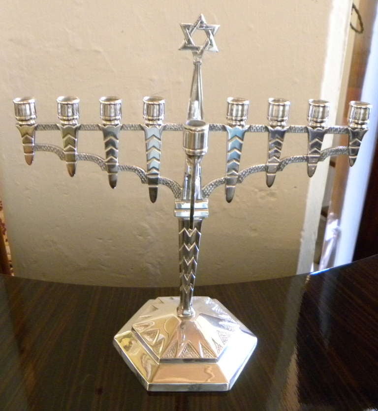 Just in time for the Holidays.  This stunning menorah is not a reproduction even though the design looks very modern.  With stylized vintage zig zag detailing and newly silver-plated on bronze art deco menorah. Some very nice details over-all and