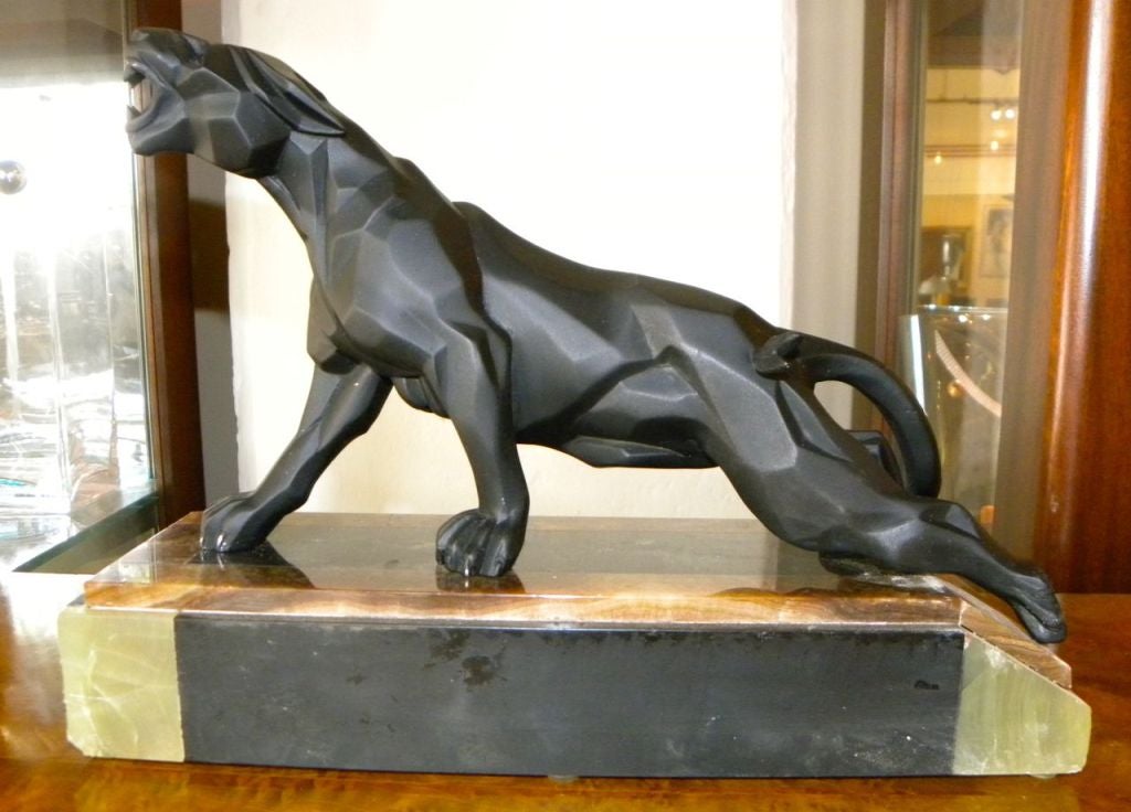 Here's a rare and magnificently intriguing 1930s Cubist sculpture of a climbing and growling panther on the prowl. The artistic facet-like details are imaginative and convey a sense a strength, power and ferocity. This bold sculpture is in excellent