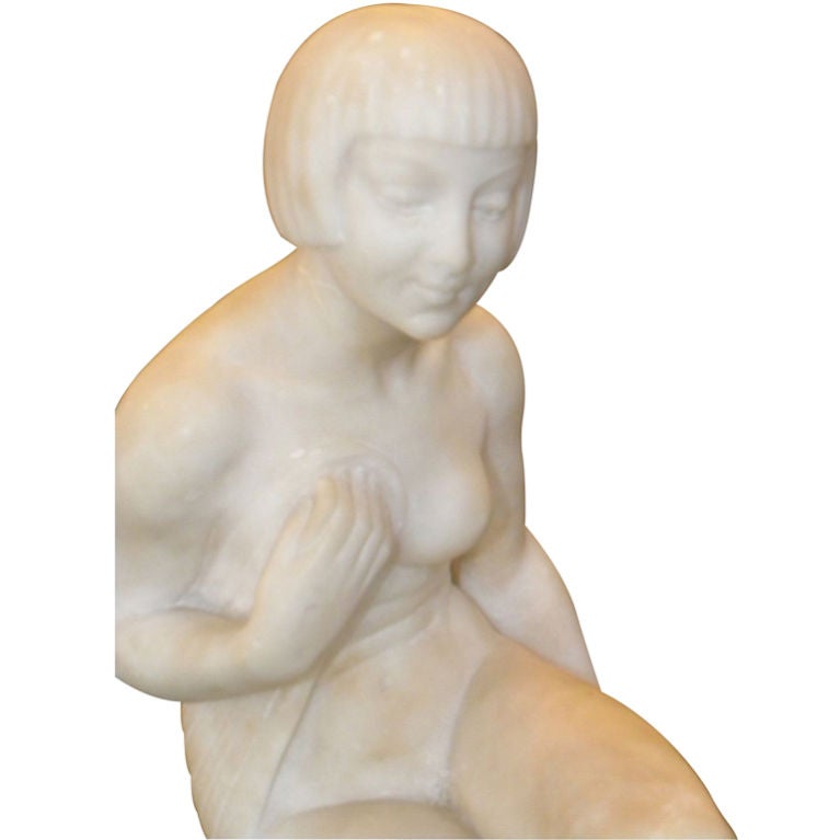 This stunning all original statue made of pure white marble, shows so much grace, talent and sophistication. The Art Deco beauty is rendered by the hands of a master: Joe Descomps whose worked is extremely sought after, often imitated and copied. He