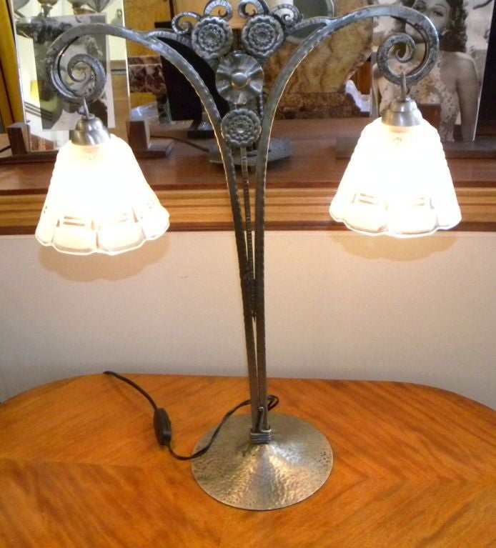 Quite unusual Sabino signed glass lamp, circa 1925.  A very unusual shape and of the finest quality from thatt time.  The iron has hand styled flowers accented by small curly vines. This piece is well balanced, sophisticated and very