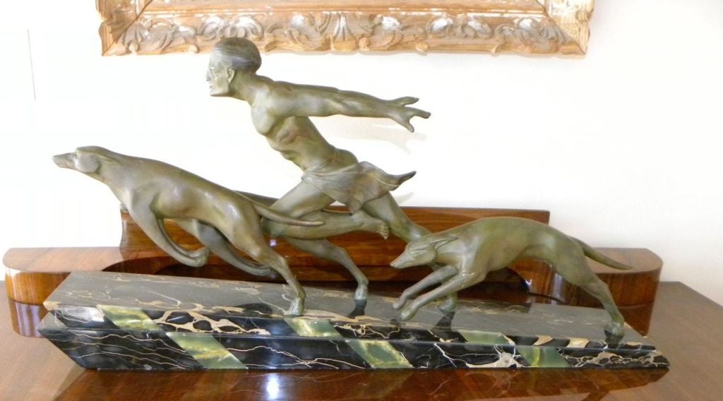 The running man with Borzoi dogs, the movement of the man and dogs reminiscent of the great male statue known by Jean de Roncourt. This one is  signed L. Valderi on the base, an artist also known for this kind of work.  Fabulous piece in the spirt