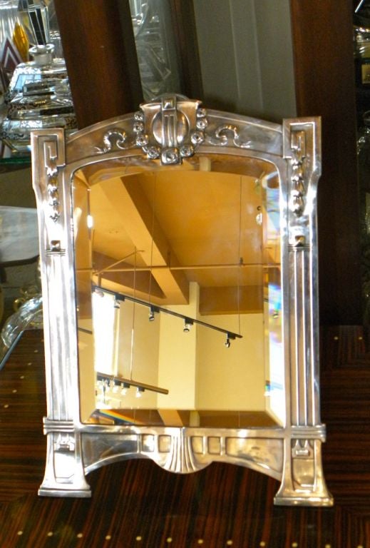 Love these wonderful mirrors and this one has all these wonderful elements.  The design is very Jugendstil, most likely WMF origin.  It really shows that nice transition of Art Nouveau going into Art Deco.  Newly silver-plated and restored.  Also a 
