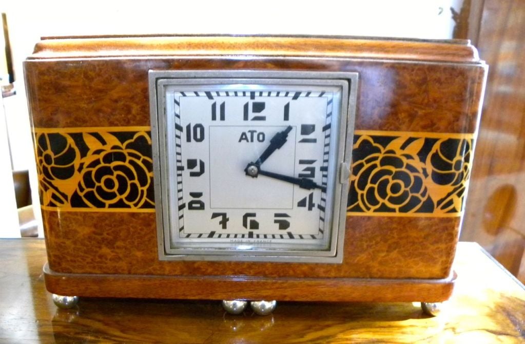 This is a wonderful wooden mantle or desk clock with great marquetry.  These early ATO clocks were very stylized and quite innovative.  These are all original battery operated clocks.  I have had many over the years, these are NOT digital quartz
