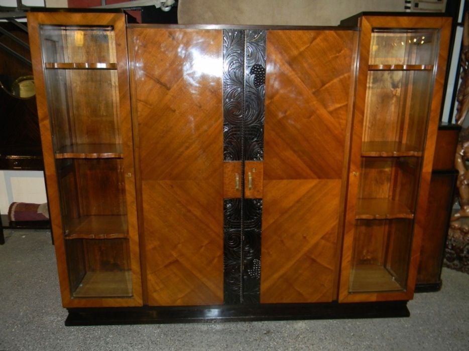 A beautiful European style Art Deco cabinet with very nice detailing. The main wood treatment is a spectacular grained sycamore, found in a lot of European Art Deco furniture. What I love about this pieces, first of all is the wonderful carving that
