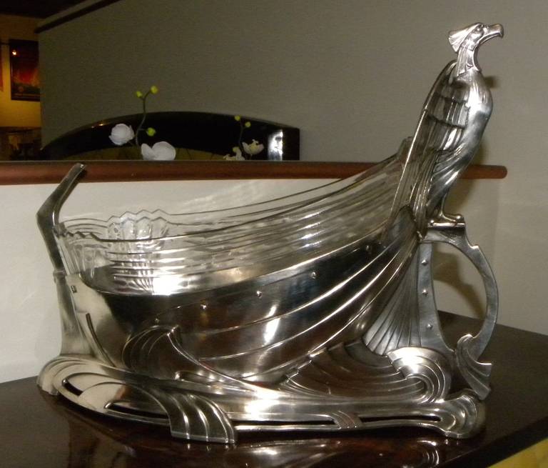 Art Nouveau-Deco Silver and  Cut Glass Centerpiece by WMF depicting stylized eagle on vessel.  This is a most unique creation, a study in contrasts. It is all at once both delicate and powerful, both “belle and bellicose”. Amazing example of the
