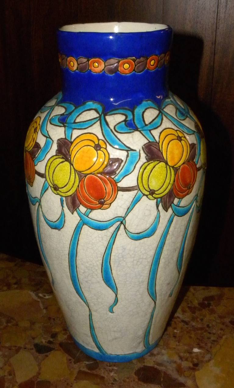 Beautiful and well documented Boch vase designed by Catteau during his tenure as design director for the Belgian company. The size of this piece is substantial and the ceramic cloisonné technique is outstanding. It looks like flowered balloons
