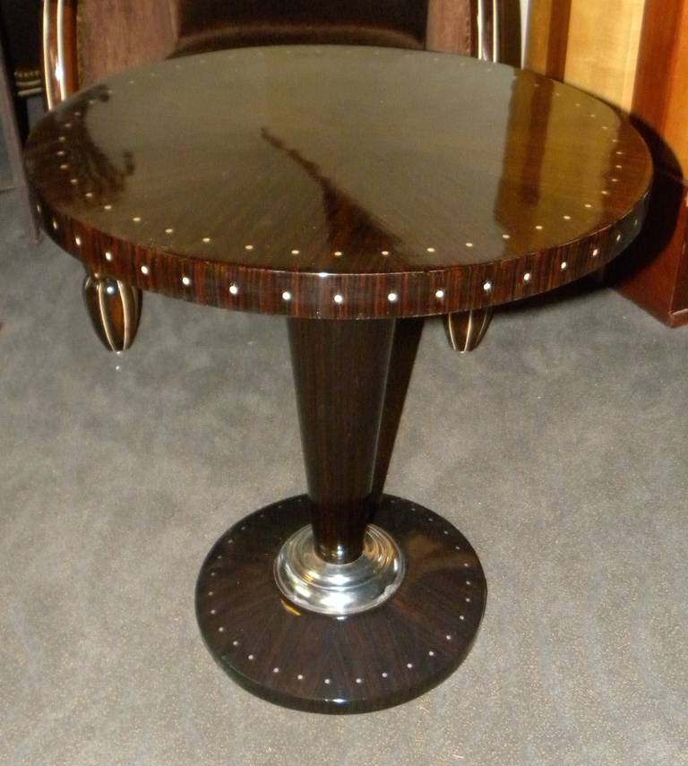 Stunning Art Deco table in the style of Ruhlmann, this custom-made piece for our shop would serve many uses in your home furnishings. Made with spectacular materials: Macassar ebony wood, ivoroid inlays and a metal collar on the base. It is one of