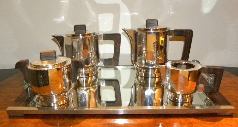 Stunning  five-piece French Art Deco coffee tea service. This modernist design and faceted shape offers all the elegance one could imagine for the finest table service. Quality set in heavy silver plated brass with strong Macassar wood handles. This
