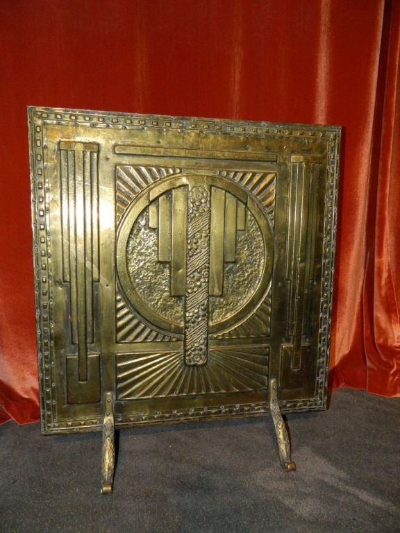 A wonderful original French fireplace cover or screen. Fabulous art deco modernist molded design with protruding speed bars, sunrise all surrounded by a stylized modernist design.  The brass or bronzed metal finish is all original and stands out as