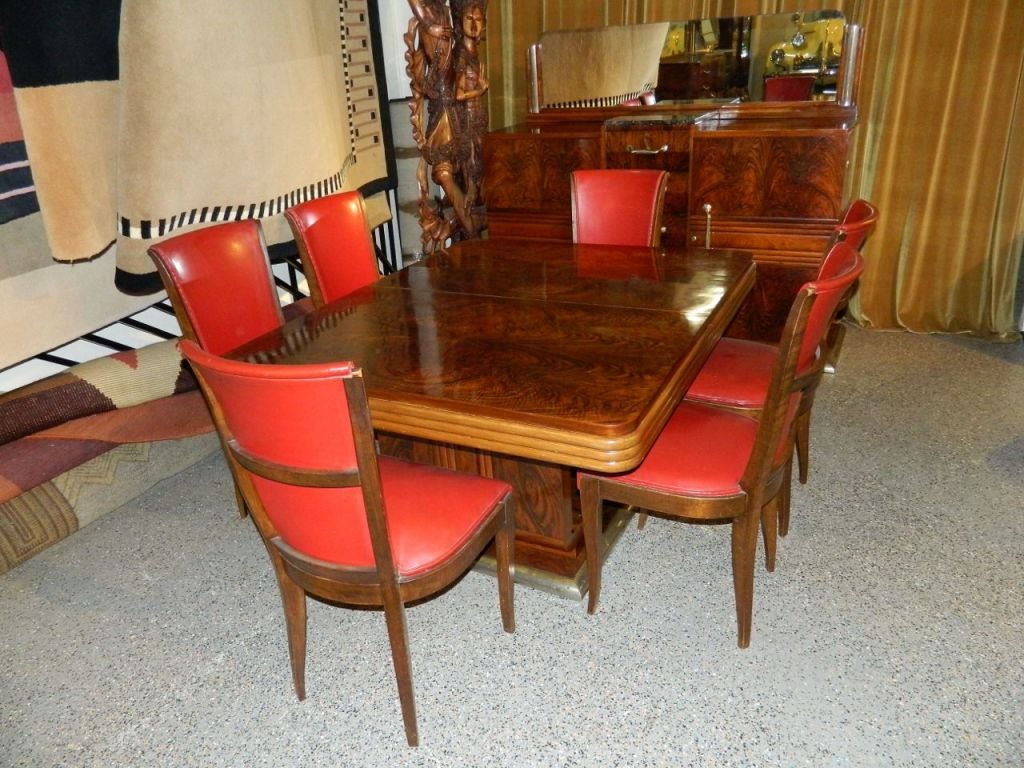 French dining suites like these do not come around often. This one is particularly unusual and spectacular in many ways. This is an original suite in amazing original condition. The combination of highly visually intense bookmatched woods is