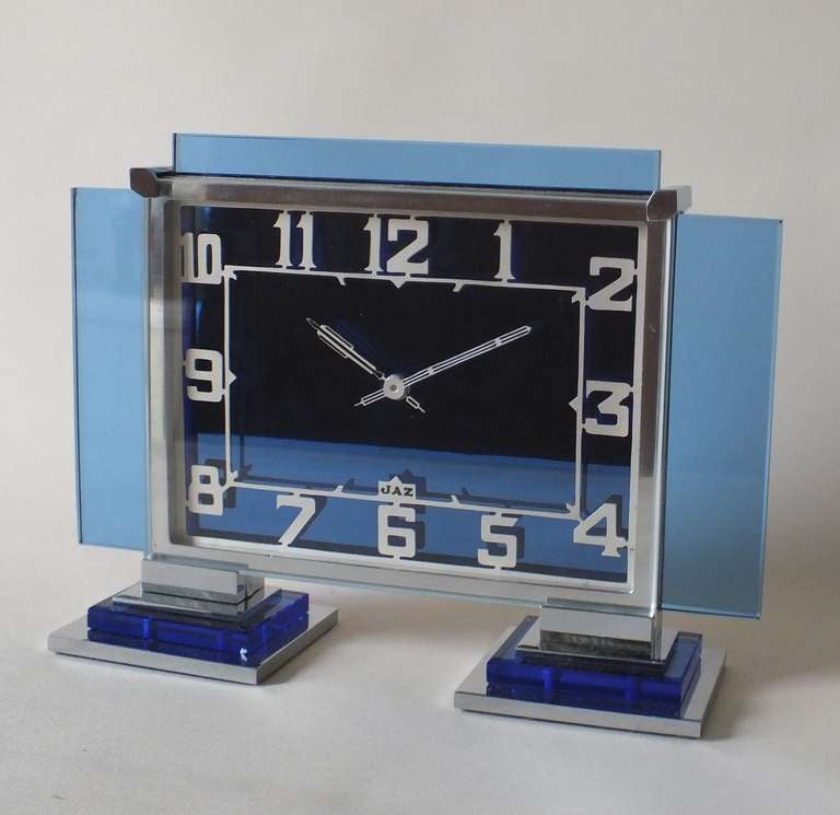 Lovely blue glass and chrome Jaz 8 day clock, in perfect working order and superb condition. Very very nice condition with deep blue color and all high quality machined chrome metal fittings.  Nice stepped design with dimensional feet utilizing both