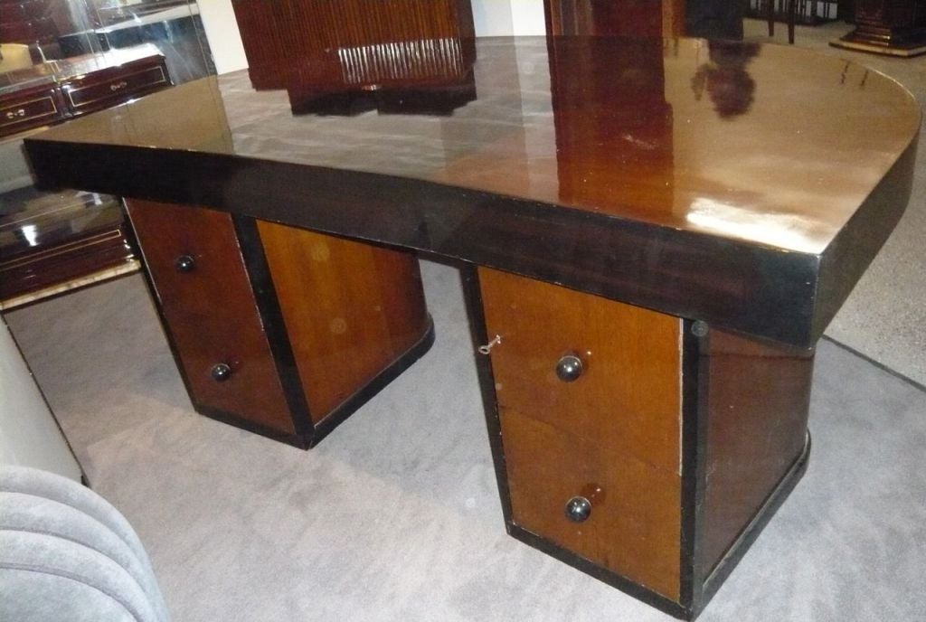 We've been waiting for this special Executive Art Deco desk for quite some time.  This is a recent restoration, all completed emphasizing the original tradition in which we found it.  A wonderful 1/2 round shaped top with strong dark desk skirt to