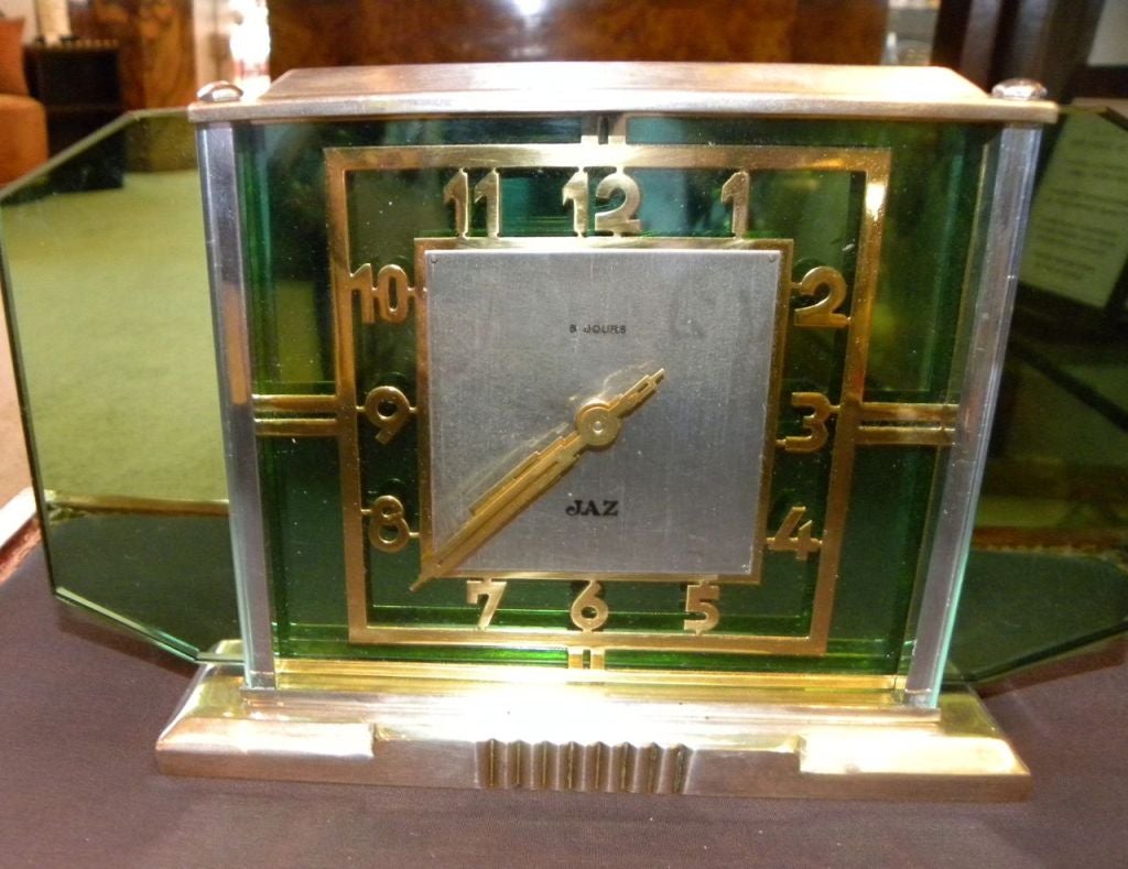 Just finished the restoration on this wonderful green glass Art Deco Jaz clock. This one has a great modernist point of view. The case has a nice weight of satin nickel, green glass and dimensional brass raised letters. It is wind up movement and