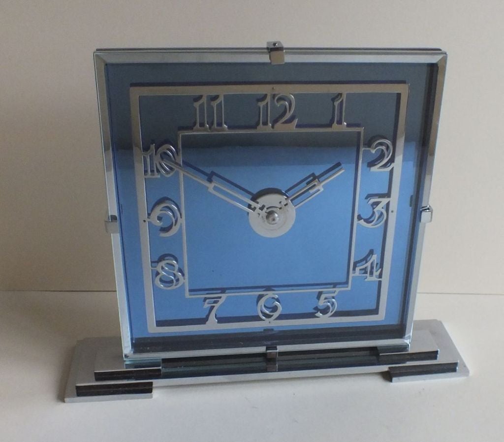 An amazing design and quality!   English 8 Day clock in Cobalt mirror and chrome, beautiful numbers and hands, great chrome platting over bronze finsih. Polished thick glass backed by matching chrome plate held together with nicely finished machined