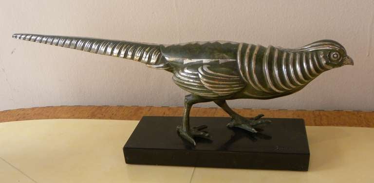 Great example of Art Deco statue by Marcel Bouraine, cold painted bronze/enamel of stylized deco pheasant. Original marble with Bouraine signature on the right corner. Great patina with silvered detail, echoes of geometric, triangular stylized