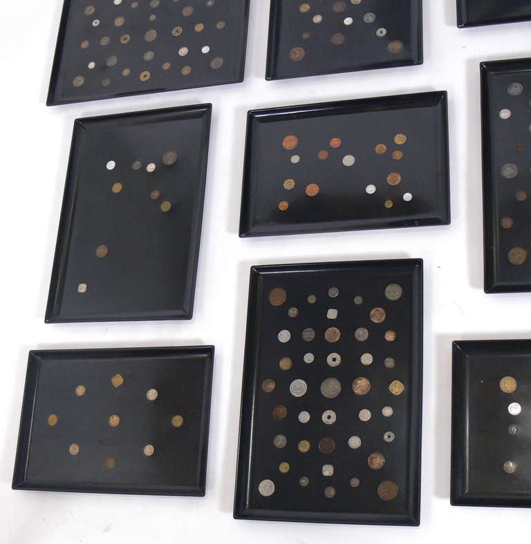 Group of Nine Coin Inlaid Trays, by The Couroc Company, American, circa 1950's. These would look great mounted on a wall together. Constructed of antique coins mounted in black resin trays.
