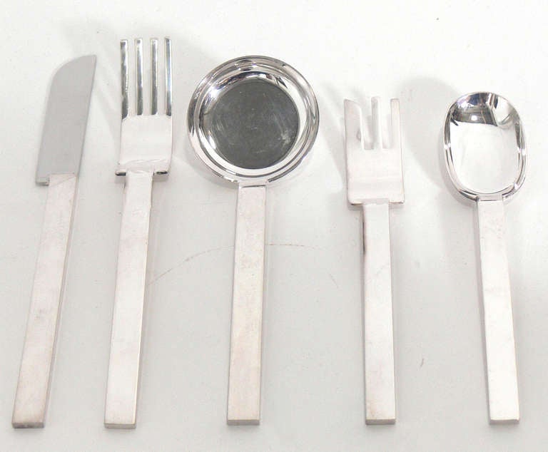 Modernist Silver Plated Flatware Set, designed by Russel Wright. Originally designed in 1933, this clean lined flatware set was briefly reissued in 1987 for the Metropolitan Museum of Art. This is a complete five piece service for eight  40 pieces