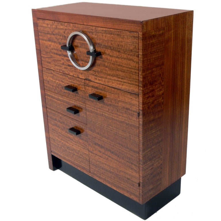 Modernist Cabinets, designed by Gilbert Rohde for Herman Miller, circa 1930's. Constructed of exotic East Indian laurel wood with black lacquered trim and nickel plated metal hardware. These are versatile pieces and can be used as desks, cabinets,