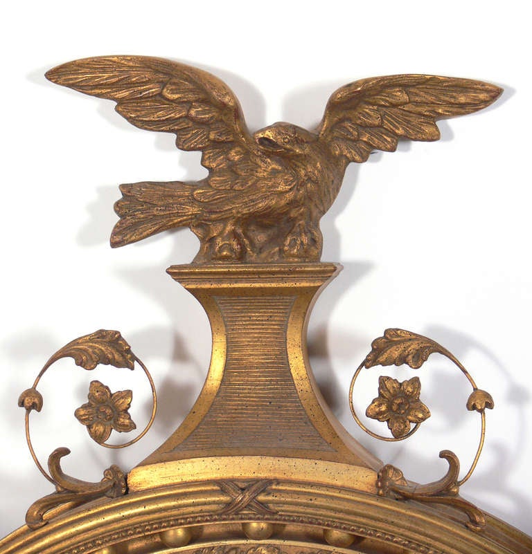 Gilt Convex Mirror with Eagle Crest, probably American, believed to be circa 1940's, possibly earlier. Elegant Regency or Federal style with wonderful patina to both frame and mirror.