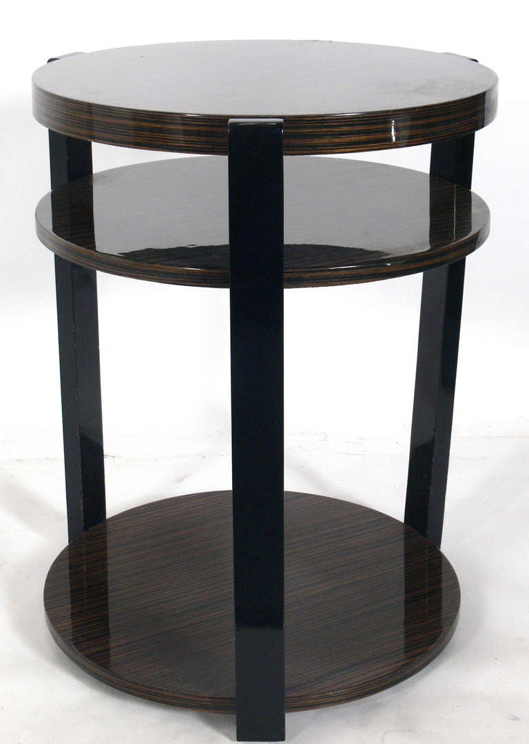 Pair of Exotic Wood Round End Tables, circa 1980's. Elegant Art Deco styling with exotic wood tops and black lacquered legs. They are a versatile size and can be used as side or end table, or as night stands or pedestals. The price noted below is