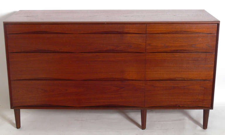 Danish Modern Chest or Credenza, Denmark, circa 1960's. This piece is a versatile size and would work as a credenza, bar, or television cabinet in a living area, or as a dresser or chest in a bedroom. Four deep drawers open to offer a voluminous
