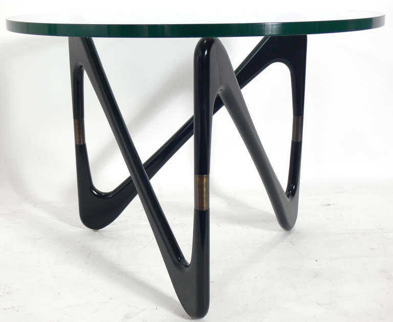 Black and Brass Side Table in the manner of Isamu Noguchi, circa 1960's. This piece has been refinished in black lacquer and retains a wonderful patina to the brass. It is a versatile size and can be used as a side or end table, or as a coffee table.