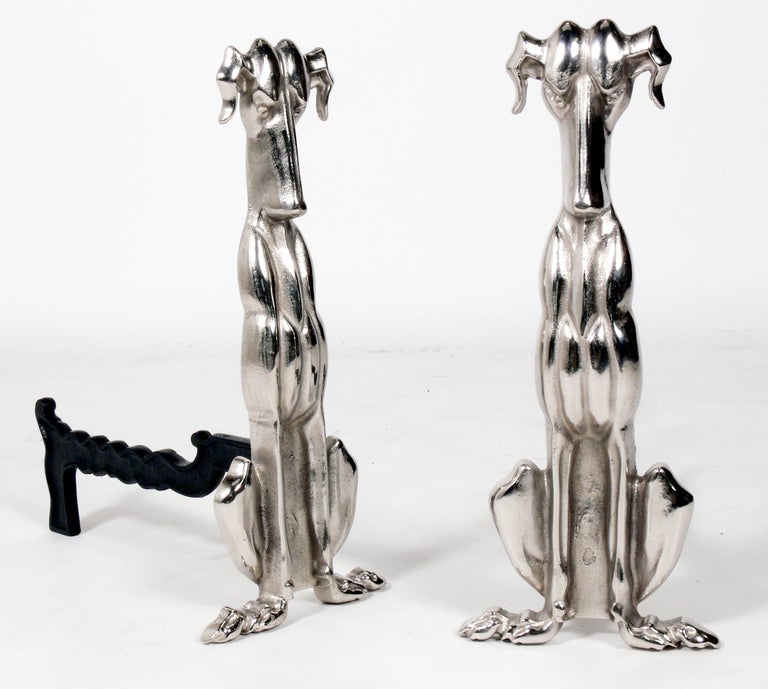Modernist Nickel Dog Andirons, produced by the Tennessee Chrome Plating Company, circa 1940's-1950's. They have been completely restored in a nickel plated finish with the legs enameled in a specialty high heat paint. 