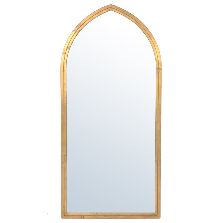 Arched Gilt Mirror circa 1960's. It exhibits wonderful original patina and wear. This mirror has a sculptural form and would fit seamlessly into a wide range of interiors, from traditional to ultra modern.

Blanket wrap shipping of this piece to