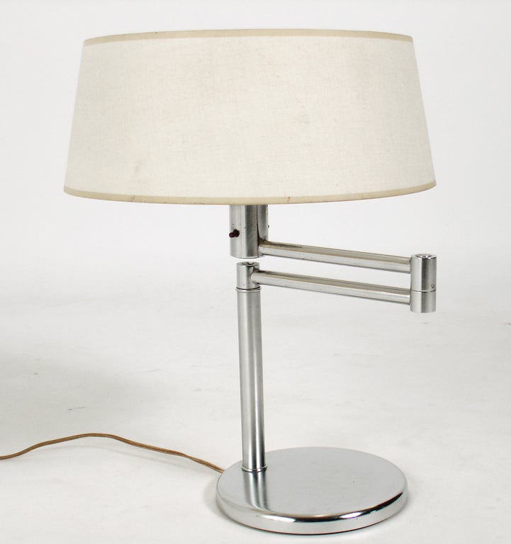 Pair of Nickel Plated Swing Arm Table Lamps, designed by Walter von Nessen, circa 1950\'s. They are the perfect reading lamps as they have a swing arm mechanism, which allows you to place the light just where you need it. They measure 19\