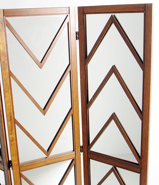 Glamorous Mirrored Chevron Folding Screen, circa 1960's. This piece is finished on the back in nicely grained walnut, so it looks great from either side. Nice attention to detail. Three hinged panels open to various angles to suit your needs. This