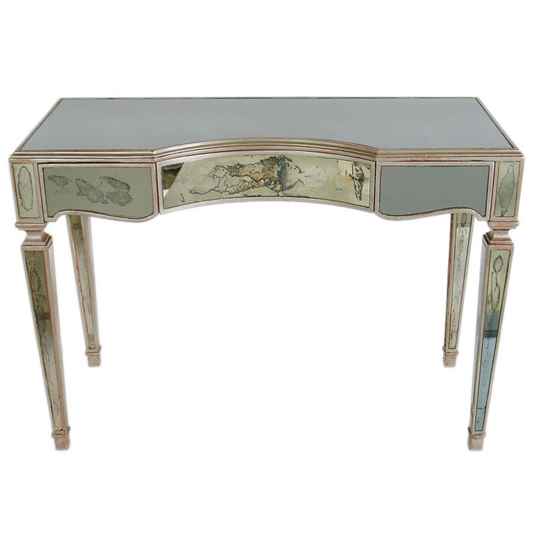 Antique Mirror and Silver Leaf Desk or Vanity, circa 1930's. It has an elegant form with wonderful patina and much wear to the silver leafing, beautifully exposing much of the Chinese Red underlayer or bole. It is a versatile size and can be used as