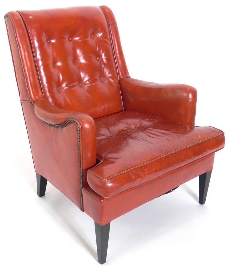 Curvaceous Lounge Chair in Original Burnt Orange Leather, American, circa 1940's. The legs have been refinished in an ultra-deep brown lacquer. Wonderful original patina and overall craquelure to leather. The leather is broken in like your favorite