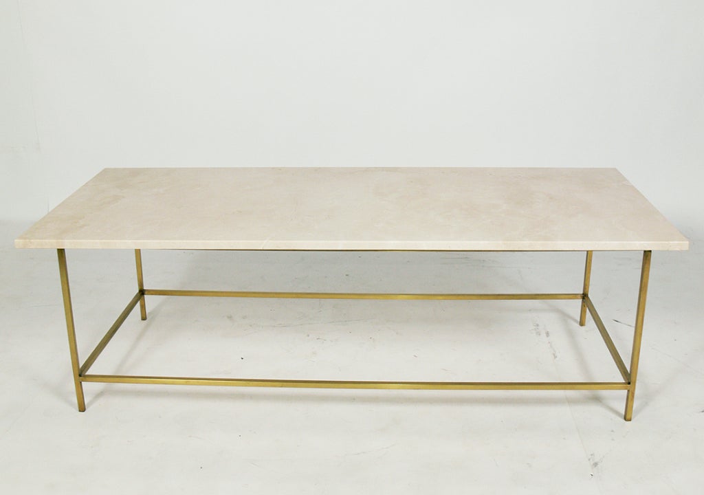 Modernist Brass and Marble Table by Paul McCobb, American, circa 1950's. Clean lined, architectural design. It has an ivory color marble top with tan veining and the brass base has been hand polished.


Blanket wrap shipping of this piece to most