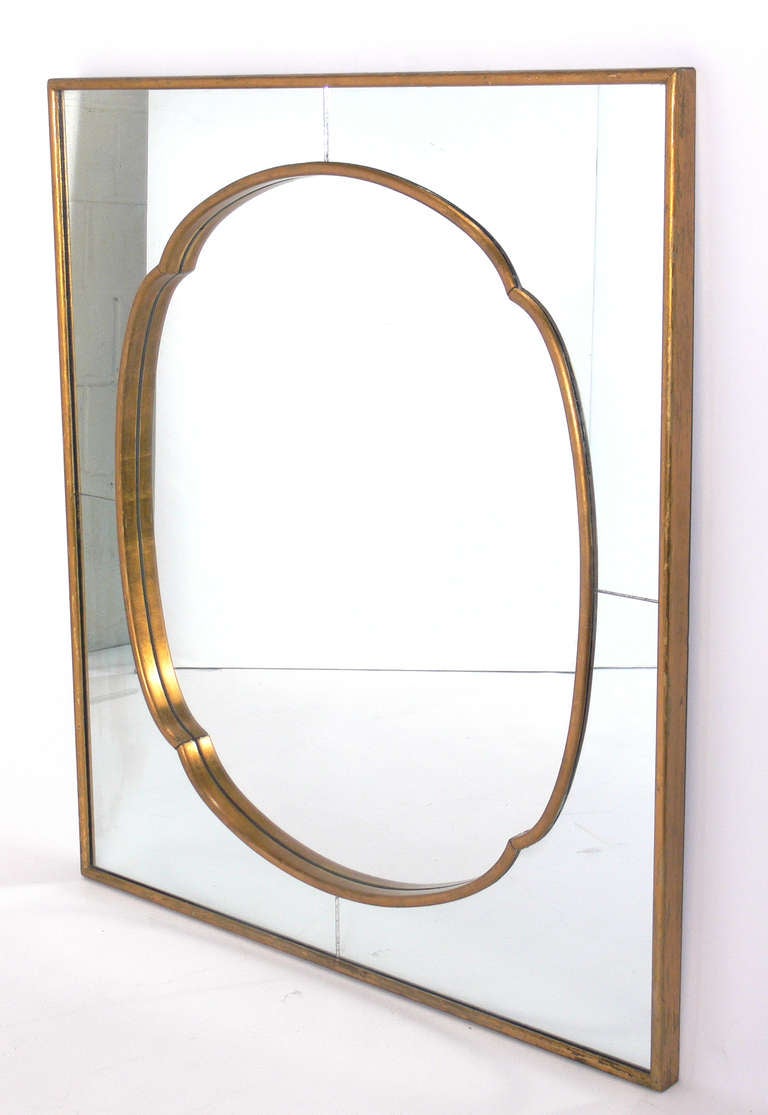 Glamorous Asian Influenced Gilt Mirror, in the manner of James Mont, American, circa 1950's. Retains wonderful original patina to the original mirrored glass and gilt wooden frame.