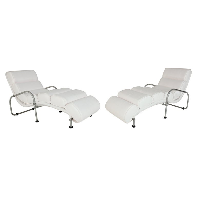 Pair of Warren McArthur Chaise Lounge Chairs, American, circa 1930's. Rare streamlined aluminum chaise lounges, recently reupholstered in white color linen upholstery. The price noted in this listing is for the pair of chaises. We are willing to