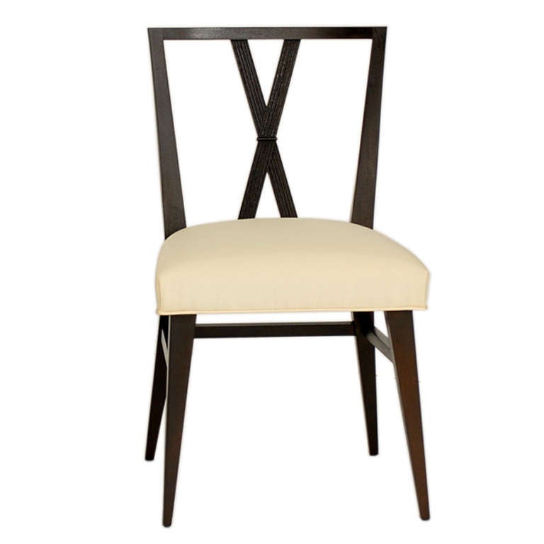 Set of Twelve Dining Chairs, designed by Tommi Parzinger for Charak, circa 1950's. This set includes ten side chairs and two arm chairs(arm chairs not shown). The price quoted in this listing is for the complete set of twelve chairs. These pieces