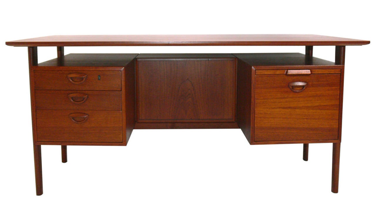Danish Modern Desk, designed by Peter Hvidt and Orla Molgaard Nielsen for Illums Bolighus(retailer), circa 1960's. This piece offers a voluminous amount of storage, and is finished on both sides, so it can be floated in a room.