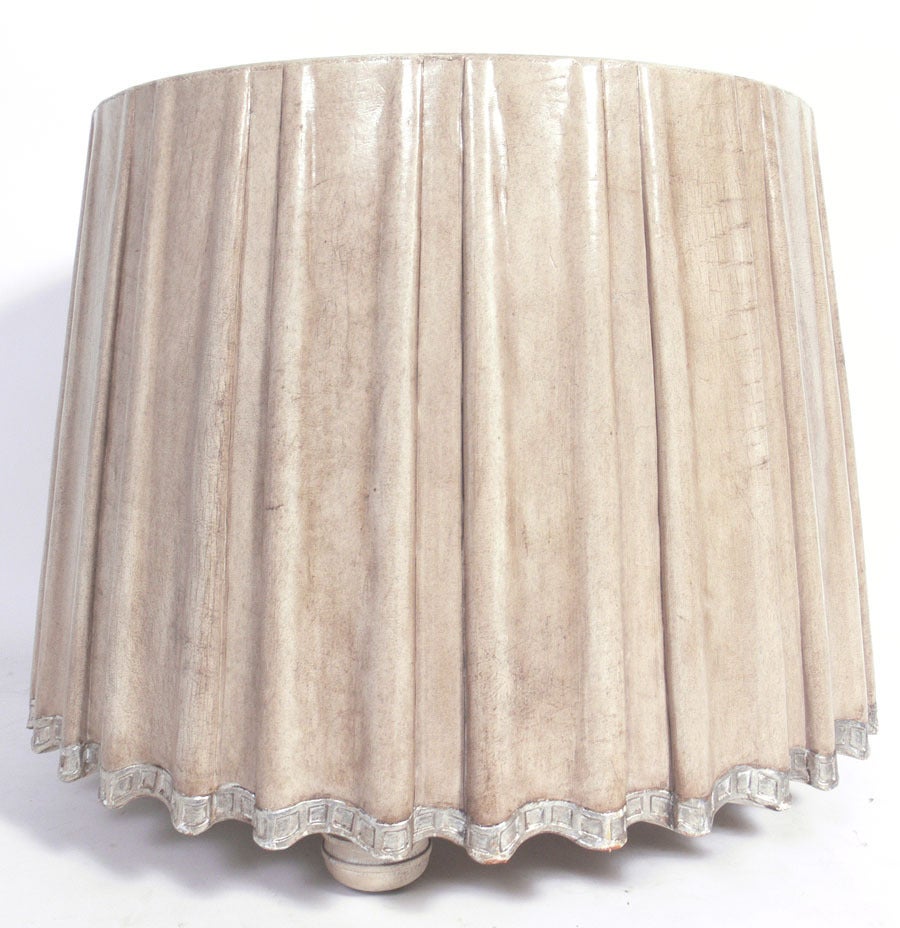 Elegant leather draped center table by Marge Carson, circa 1980s. 
Constructed of antiqued ivory color leather with silver leafed details at the base. It is a versatile size and can be used as a center or end table as is, or as a game table or low