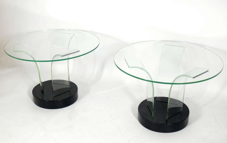 Sculptural Glass End Tables, designed for the Modernage Company of New York City, circa 1940's. The wooden bases have been refinished in an ultra-deep brown color lacquer. They retain their original glass supports and table tops.