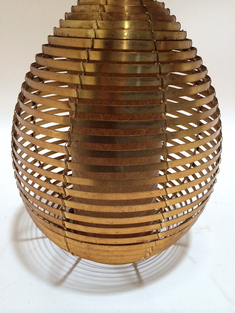 *One has been sold. 

Brass Beehive Pendant Light Fixture, in the manner of Paavo Tynell, circa 1950's. The price is $550 for a single fixture.